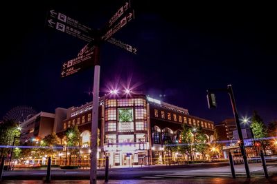 Low angle view of illuminated building against sky at night