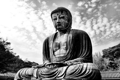 Low angle view of statue against sky