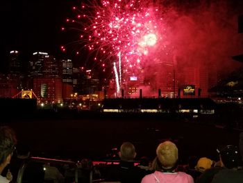 Firework display in city at night