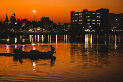 Scenic view of lake against sky at sunset