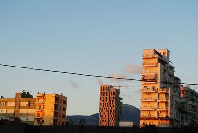 Low angle view of cityscape against clear sky