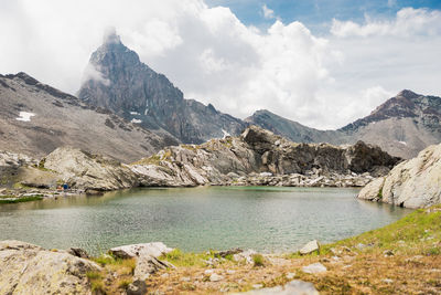 Scenic view of lake and mountains against sky