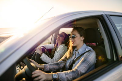 Reflection of woman sitting in car