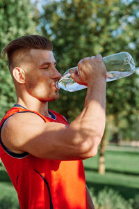 Young man drinking water