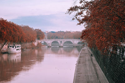 Bridge over river against sky during autumn