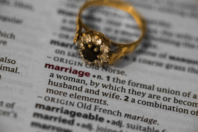 Wedding ring on dictionary page with marriage text highlighted in red