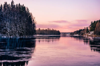 Scenic view of lake against sky at sunset