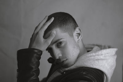 Portrait of young man looking away at home