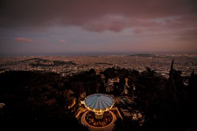 High angle view of city lit up at night