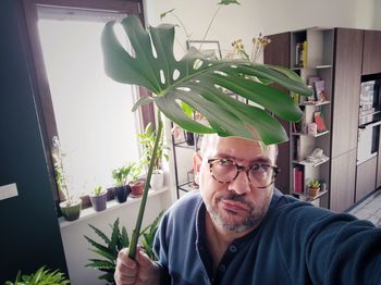 Portrait of man with potted plants