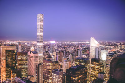 Aerial view of city lit up at night