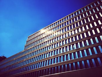 Low angle view of modern building against clear blue sky