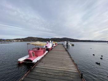 Pier over lake against sky