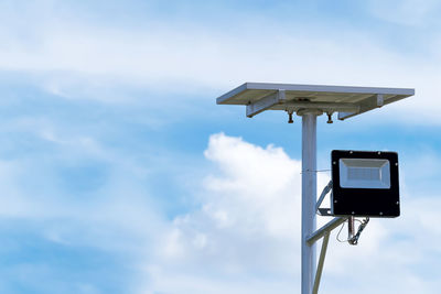 Low angle view of information sign against sky