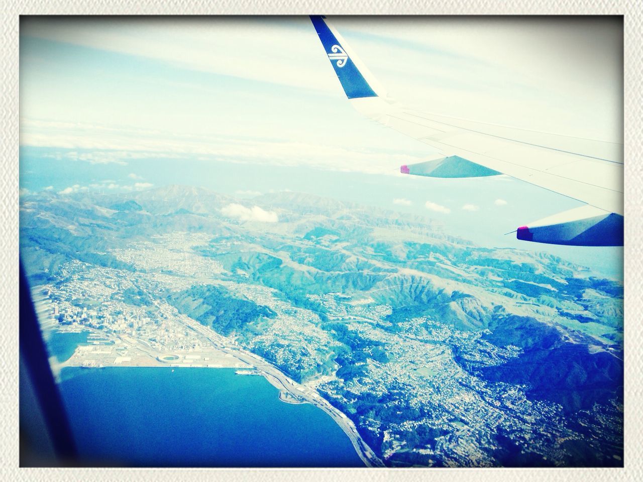 airplane, air vehicle, aircraft wing, aerial view, transportation, landscape, flying, mode of transport, mountain, part of, scenics, travel, snow, cropped, beauty in nature, journey, mountain range, mid-air, sky, nature