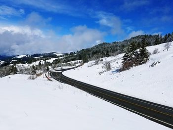 Scenic view of snow covered mountains against sky