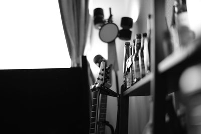 Close-up of guitar by shelf