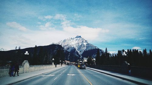 Road against snow covered mountains