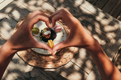 Cropped hand of woman holding heart shape