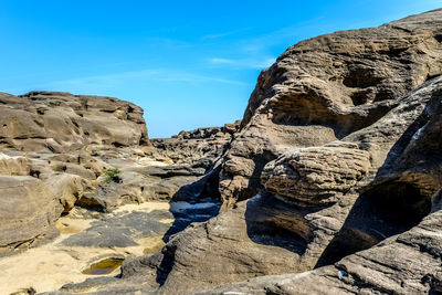 View of rock formation on land against sky