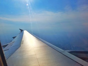 Airplane flying over sea against sky