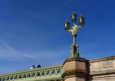 Low angle view of statue against blue sky