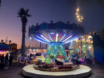 Illuminated ferris wheel at night