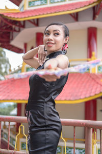 Portrait of young woman exercising in gym
