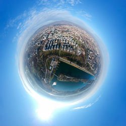 Close-up of modern cityscape against blue sky