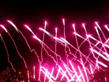 Low angle view of firework display at night
