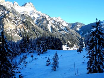 Scenic view of snow covered mountains against sky