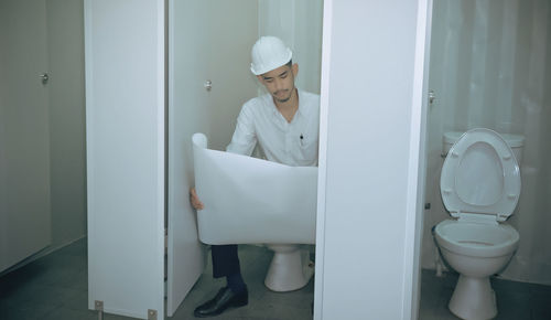 Man working in bathroom