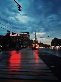 Illuminated street lights in city at dusk