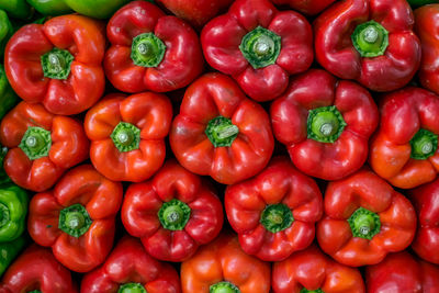 Fresh red bell peppers arranged at the market