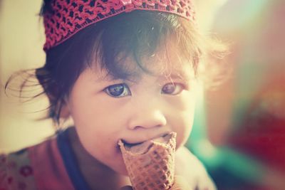 Close-up portrait of cute girl eating ice cream