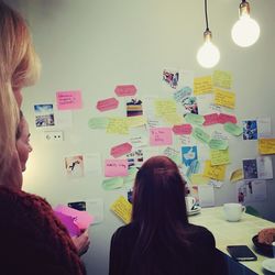 Rear view of young woman looking through window
