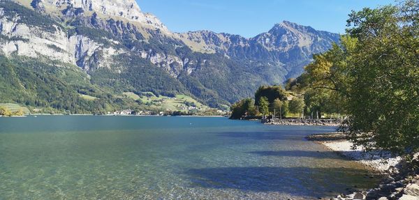 Scenic view of sea and mountains against sky