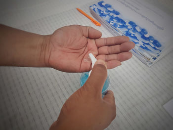 High angle view of person hand holding paper