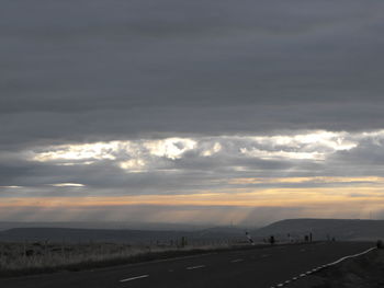 Scenic view of landscape against cloudy sky