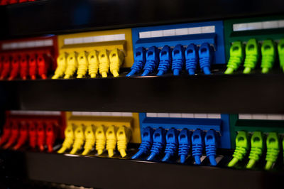 Close-up of multi colored bottles in shelf