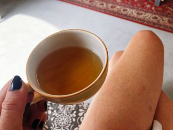 Midsection of woman holding coffee cup