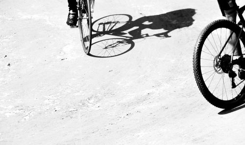 Low section of person riding bicycle on street