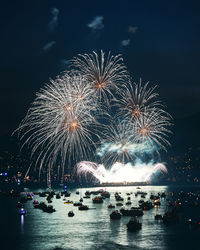 Firework display over river at night