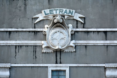 Low angle view of clock on wall of building