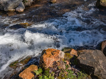 Scenic view of rocks in sea against sky