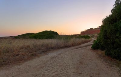 Scenic view of field against clear sky during sunset