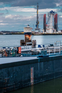 Commercial dock by sea against sky