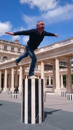 Full length of man jumping in city