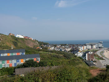 Townscape by sea against sky in city