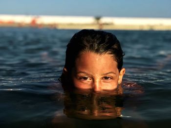 Portrait of girl swimming in sea